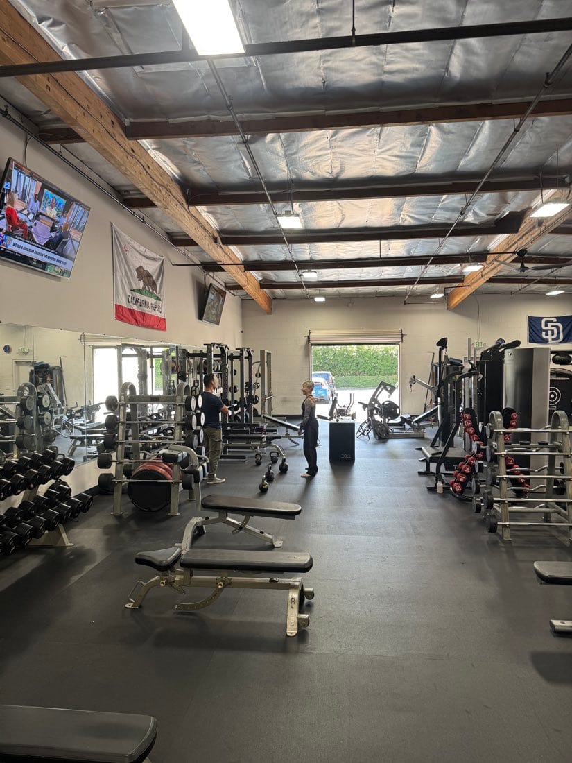 Benches and free weights near the open garage door